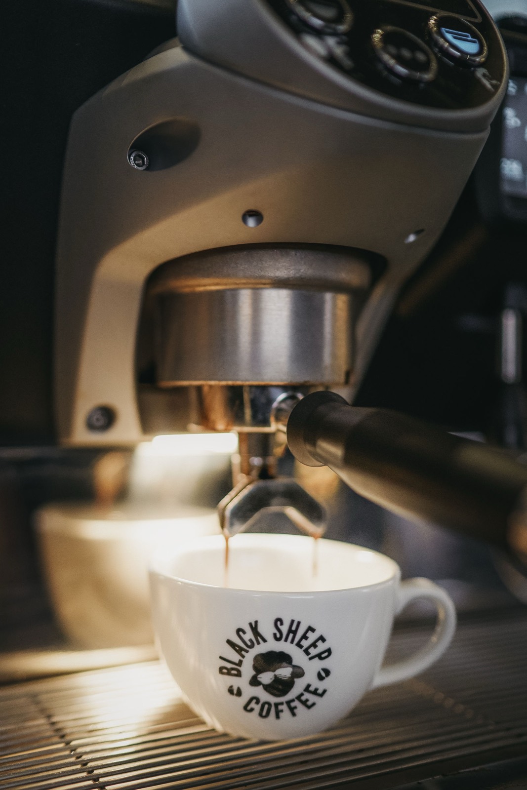 Espresso pulling into a branded cup on the machine.
