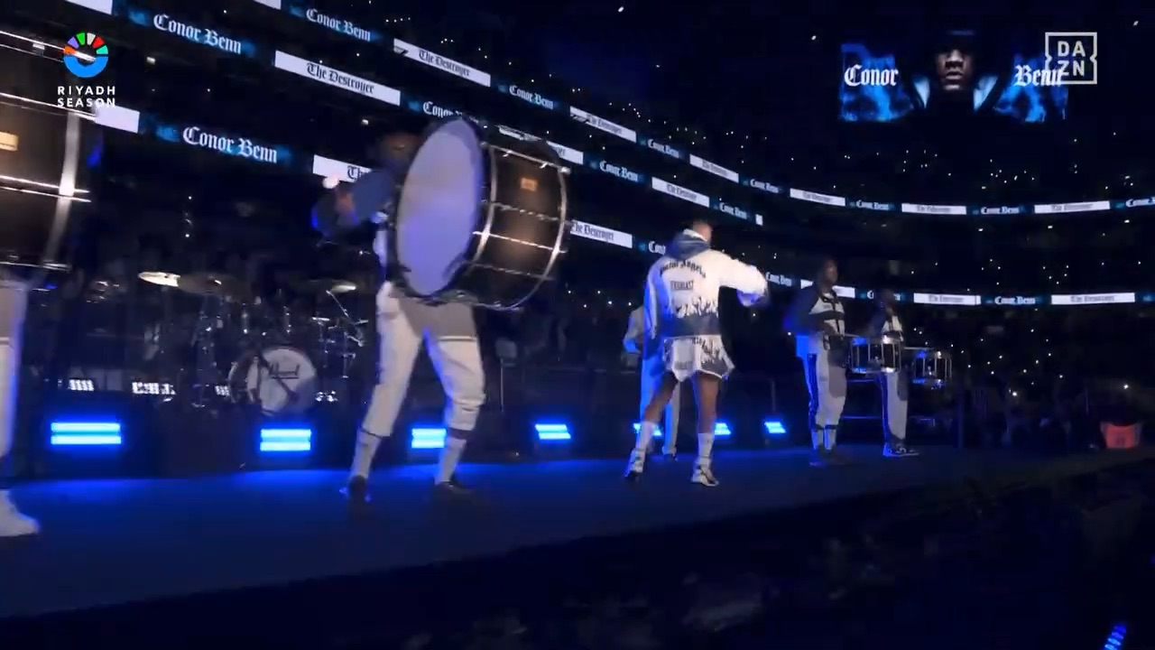 A live drumline leading Conor Benn down the ramp, his name wrapping the stadium.