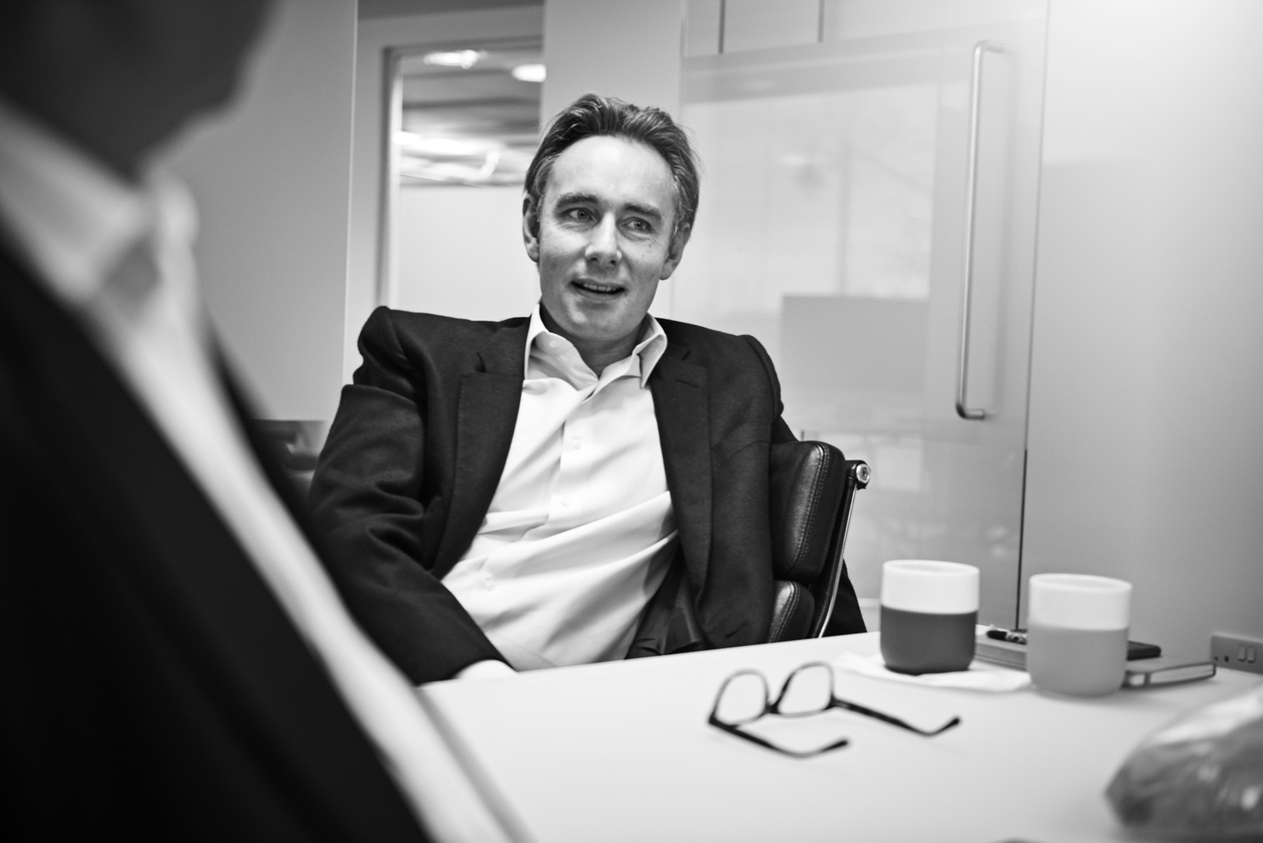 Christian in conversation across a meeting table.