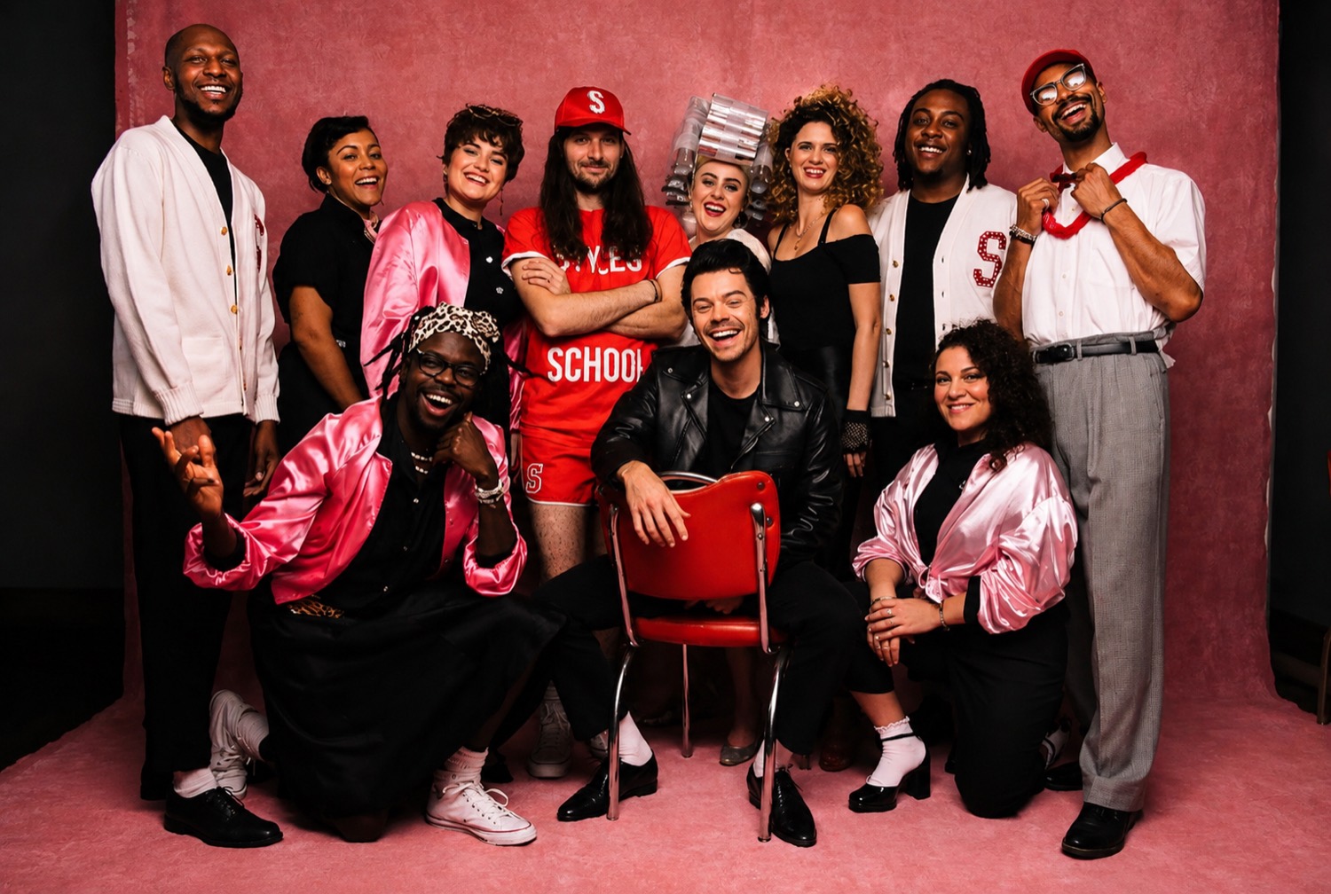 The touring band and crew photographed together.