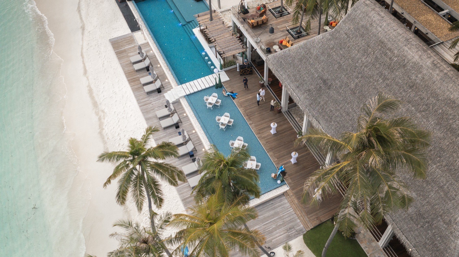 The island from the air: pool, beach and lagoon.